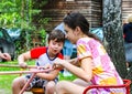 Chelyabinsk, Russia-August 08, 2020:Children spin on a spinning carousel on the Playground in summer Royalty Free Stock Photo