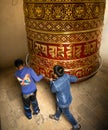 Children spinning prayer wheel