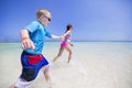 Children splashing in the ocean on a tropical beach vacation Royalty Free Stock Photo