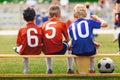 Children in Sports Team. Happy Kids in Sportswear with Ball Sitting on Soccer Football Bench Royalty Free Stock Photo