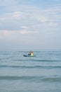 Children standing on the floating raft water craft in the sea