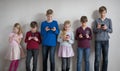 Children standing and everyone using their own mobile phone