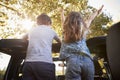 Children Standing Up In Back Of Open Top Car On Road Trip Royalty Free Stock Photo