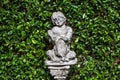 Children statue and green background Royalty Free Stock Photo