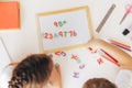 Children study the letters on the magnet and put them in a row on the board Royalty Free Stock Photo