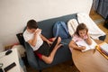Children studying at home using laptop and notebook Royalty Free Stock Photo
