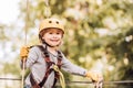 Children summer activities. Adventure climbing high wire park. Cute baby boy playing. Hiking in the rope park girl in Royalty Free Stock Photo