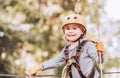 Children summer activities. Adventure climbing high wire park. Cute baby boy playing. Hiking in the rope park girl in Royalty Free Stock Photo