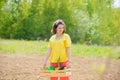 Children summer activities. Happy kids work plant and water in green spring garden.