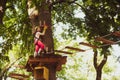 Children summer activities. Rope way - little girl is looking at the rope slideway fearing. Looking away with fear of Royalty Free Stock Photo