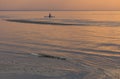 Children silhouettes at sunset at sea.