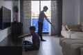 Children sweeping floor and cleaning dust in living room at home. Housekeeping and household Royalty Free Stock Photo