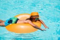 Children swim with floating ring in swimming pool. Kids summer vacation. Happy little boy with inflatable ring in Royalty Free Stock Photo