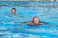 Children swim in pool outside in  water park. cheerful kids active water sports in summer. children`s holidays at  sea Royalty Free Stock Photo