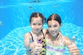 Children swim in pool underwater, happy active girls have fun under water, kids sport Royalty Free Stock Photo