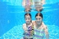 Children swim in pool underwater, happy active girls have fun under water Royalty Free Stock Photo