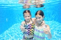 Children swim in pool underwater, happy active girls have fun under water Royalty Free Stock Photo