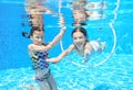 Children swim in pool underwater, happy active girls have fun under water Royalty Free Stock Photo