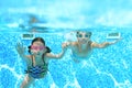 Children swim in swimming pool underwater, happy active girls have fun under water, kids fitness and sport