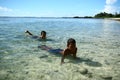 Children swimming in the beach of Samoa