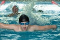 Khabarovsk, Russia - May, 19, 2019: children swimming Butterfly. Indoor swimming pool with clear blue water Royalty Free Stock Photo