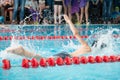 Children swimming freestyle. Indoor swimming pool with clear blue water. Royalty Free Stock Photo