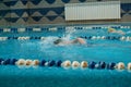 Children swimming freestyle. Indoor swimming pool with clear blue water. Royalty Free Stock Photo