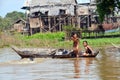 Children swimming in the murky waters of the Tonle Sap River, jumping from boat