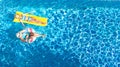 Children in swimming pool aerial drone view fom above, happy kids swim on inflatable ring donut and mattress, girls have fun Royalty Free Stock Photo