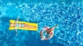 Children in swimming pool aerial drone view fom above, happy kids swim on inflatable ring donut and mattress, girls have fun Royalty Free Stock Photo