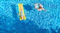 Children in swimming pool aerial drone view fom above, happy kids swim on inflatable ring donut and mattress, girls have fun Royalty Free Stock Photo