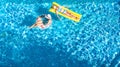 Children in swimming pool aerial drone view fom above, happy kids swim on inflatable ring donut and mattress, girls have fun Royalty Free Stock Photo