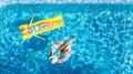 Children in swimming pool aerial drone view fom above, happy kids swim on inflatable ring donut and mattress, girls have fun