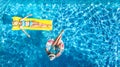 Children in swimming pool aerial drone view fom above, happy kids swim on inflatable ring donut and mattress, girls have fun Royalty Free Stock Photo