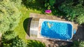 Children in swimming pool aerial drone view fom above, happy kids swim on inflatable ring donut and mattress, girls have fun Royalty Free Stock Photo