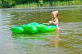Children swimming in the river with inflatable tur Royalty Free Stock Photo