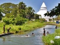 Children swimming in the river, Tissamarahama, with stupa, Sri Lanka Royalty Free Stock Photo