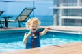 Kids swim in roof top swimming pool Royalty Free Stock Photo