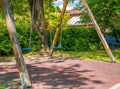 Children swings in a park with trees Royalty Free Stock Photo