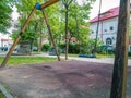 Children swings in a park with trees Royalty Free Stock Photo