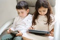 Faceless children with tablet computer and mobile phone. Kids study online. Little girl with laptop pc and boy with cell Royalty Free Stock Photo