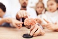 Children with teacher looking at a model of the human brain.