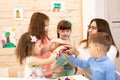 Children and teacher putting hands together like a team Royalty Free Stock Photo