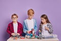 Children teamwork assembling robots isolated Royalty Free Stock Photo
