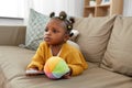 African american baby girl with smartphone at home Royalty Free Stock Photo