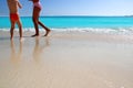 Children and teen legs playing Caribbean beach