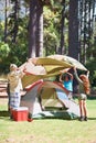 Children, tent and camping setup in forest for shelter, cover or insurance together on the grass in nature. Happy kids
