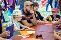 Children and their parents participating at arts and craft outdoors workshop