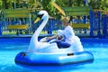 Children and their parents ride water catamarans inflatable in Gorky park in Kharkiv
