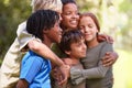 Children, together and hug with diversity in nature adventure, support and bonding on summer camp. Kids, embrace with Royalty Free Stock Photo